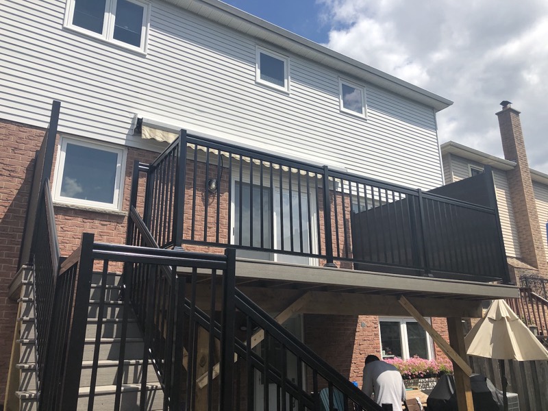 Raised composite deck with aluminum railing and stairs